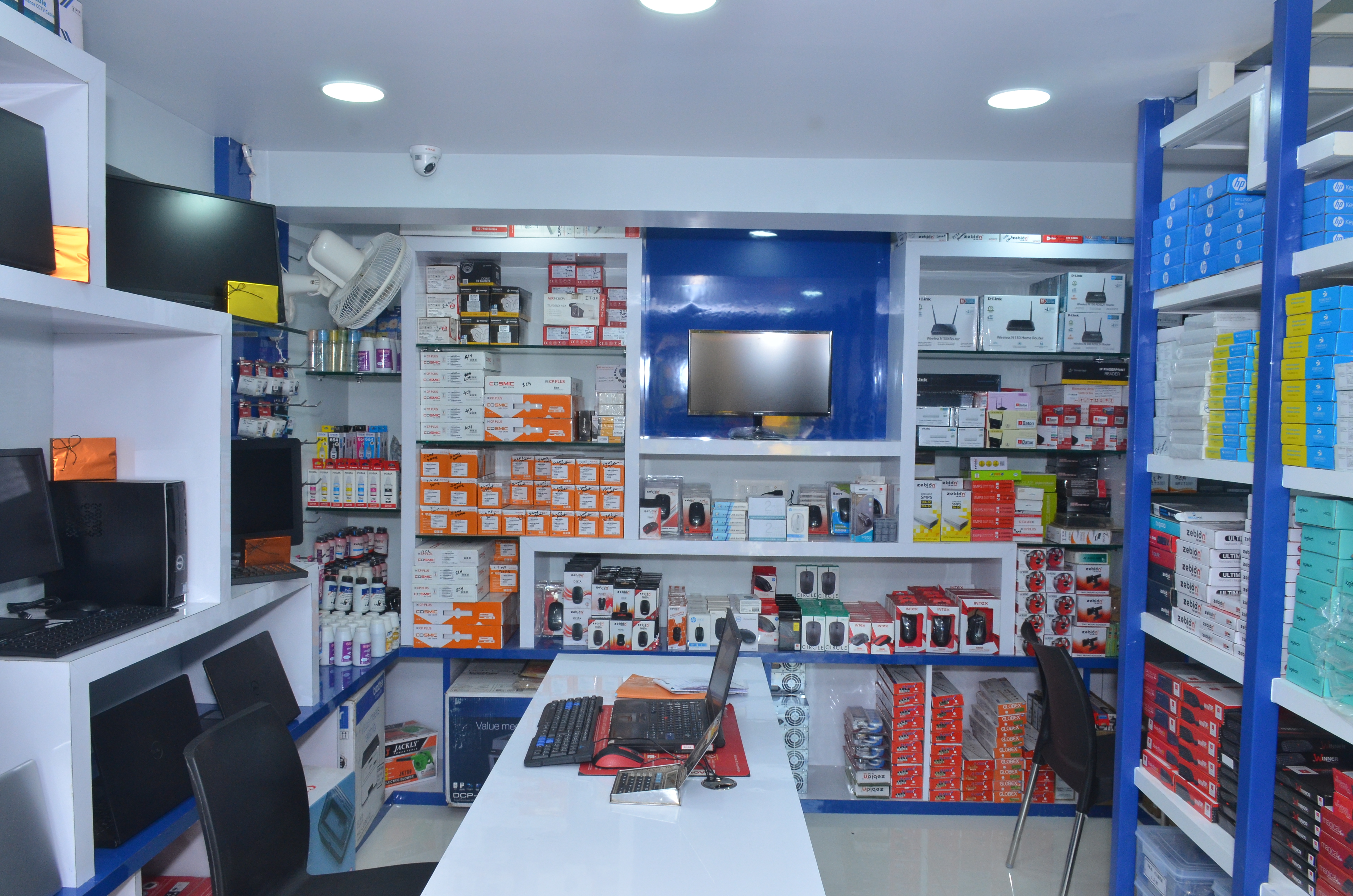 Service counter with technicians performing laptop repairs — Laxmi Computer Service